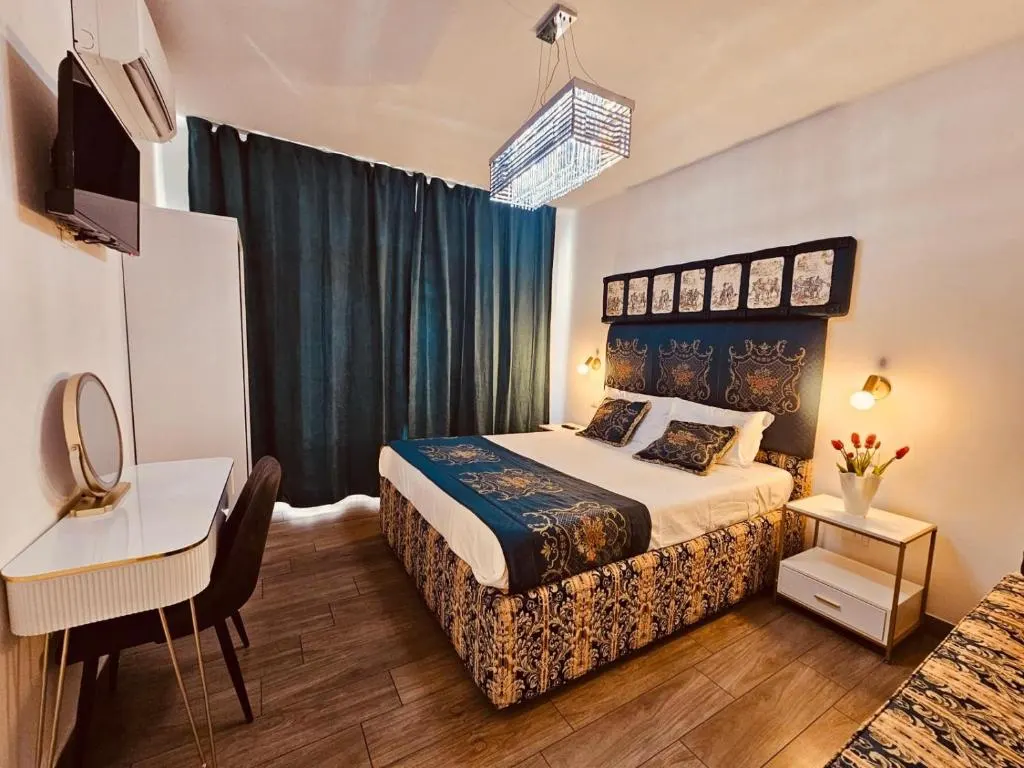 Royal Suites Venice — Superior Suite with crystal chandelier at dusk